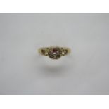 A Victorian 18ct gold garnet and seed pearl ring in a star and crescent setting, stamped 18ct and