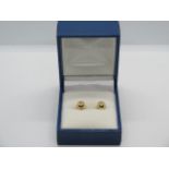 A pair of 18ct gold and diamond stud earrings, each set with five small diamonds and hallmarked to