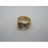 An 18ct gold and diamond buckle ring set with two small round cut diamonds, ring size Q, weight