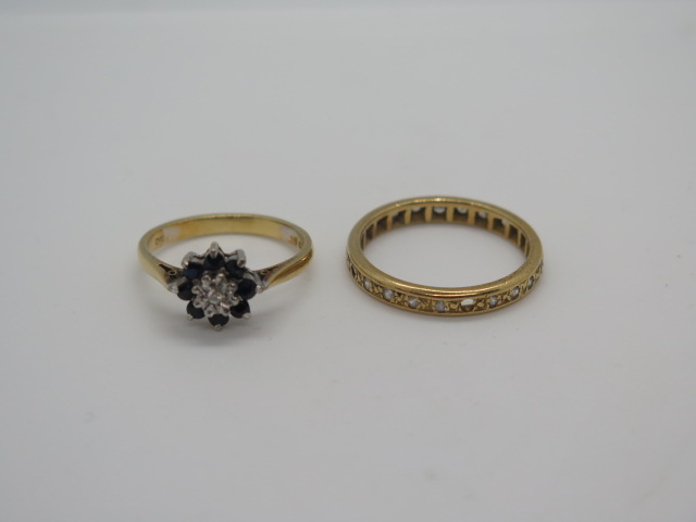 An 18ct gold and white stone eternity ring with a stone missing and rubbing to others, size P, and