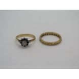 An 18ct gold and white stone eternity ring with a stone missing and rubbing to others, size P, and