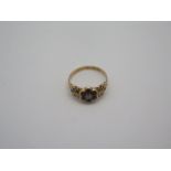 A Victorian 15ct gold garnet and diamond ring, set with six garnets and ten small diamonds, the