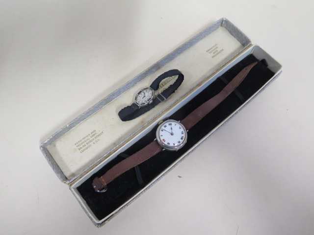 An 18ct white gold sapphire and diamond Art Deco cocktail watch and a silver trench watch, approx