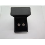 A pair of 18ct gold diamond cluster earrings, hallmarked on posts, each having a total of nineteen