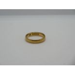 A hallmarked 22ct gold band ring, size O/P, approx 5.2 grams, some general usage marks, otherwise