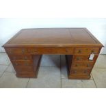 A well restored Victorian oak nine drawer twin pedestal desk with a leather inset top, 74cm tall x