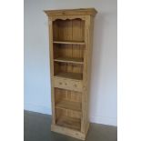 A stripped pine bookcase with a drawer - 181cm tall x 62cm x 35cm