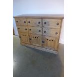 A good quality waxed pine bank of six drawers and three cupboards - 117cm wide x 86cm high