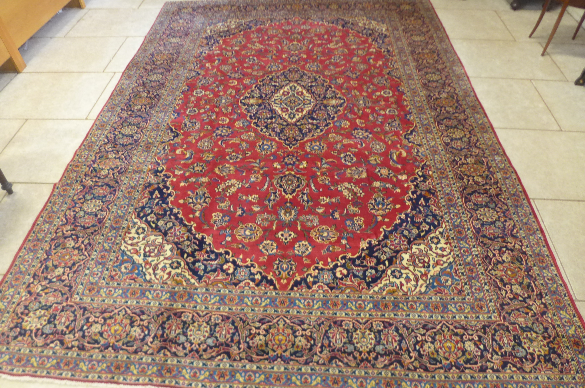 A hand knotted woollen Kashan rug - 380cm x 267cm