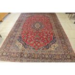 A hand knotted woollen Kashan rug - 380cm x 267cm