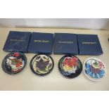 Four Moorcroft pin dishes all boxed, in good condition
