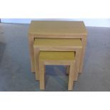 A nest of three oak side tables, 58cm tall x 64cm x 32cm