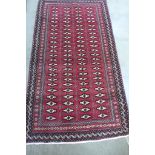 A hand knotted woollen Turkman rug - 215cm x 120cm