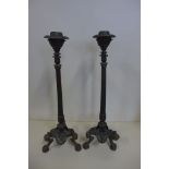 A pair of bronze tri form candlesticks, 36cm tall, both with good patina, slight lean to one