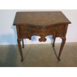 A marquetry inlaid bow fronted side table with a frieze drawer above two small drawers, and a shaped