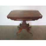 A 19th century mahogany fold over card table on a quatrefoil base with splayed legs, 76cm tall x
