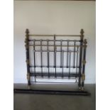 A Victorian brass and iron 4'6 inch bed with side rails, headboard 59 inches tall