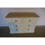 A painted white chest with four drawers, 102cm wide, 76cm high