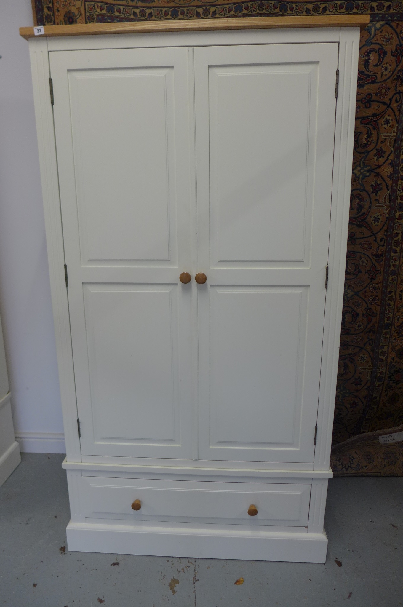 A white painted double wardrobe with a single drawer 197cm high, 107cm wide