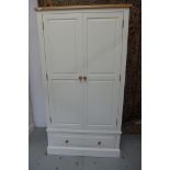 A white painted double wardrobe with a single drawer 197cm high, 107cm wide