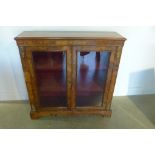 A 19th century walnut inlaid two door cabinet with ormulu mounts on bracket feet, 107cm tall x 105cm