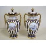 A pair of Royal Crown Derby twin handled lidded vases, with hand painted scenes of Whitby and