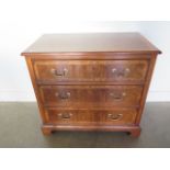 A walnut veneered three drawer chest on bracket feet, made by a local craftsman incorporating