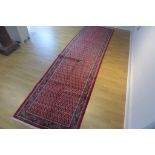 A hand knotted woollen Araak rug - 370cm x 102cm