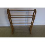 A polished pine towel rail