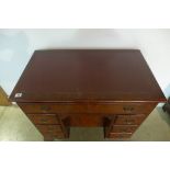 A Georgian style mahogany kneehole seven drawer desk, 77cm tall, 78x46cm