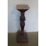 A late Victorian oak pedestal with rogue marble top, the carved column with ionic capitals, on a