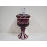 A ruby overlay glass lidded goblet with vine and grape decoration, 34cm tall, in good condition