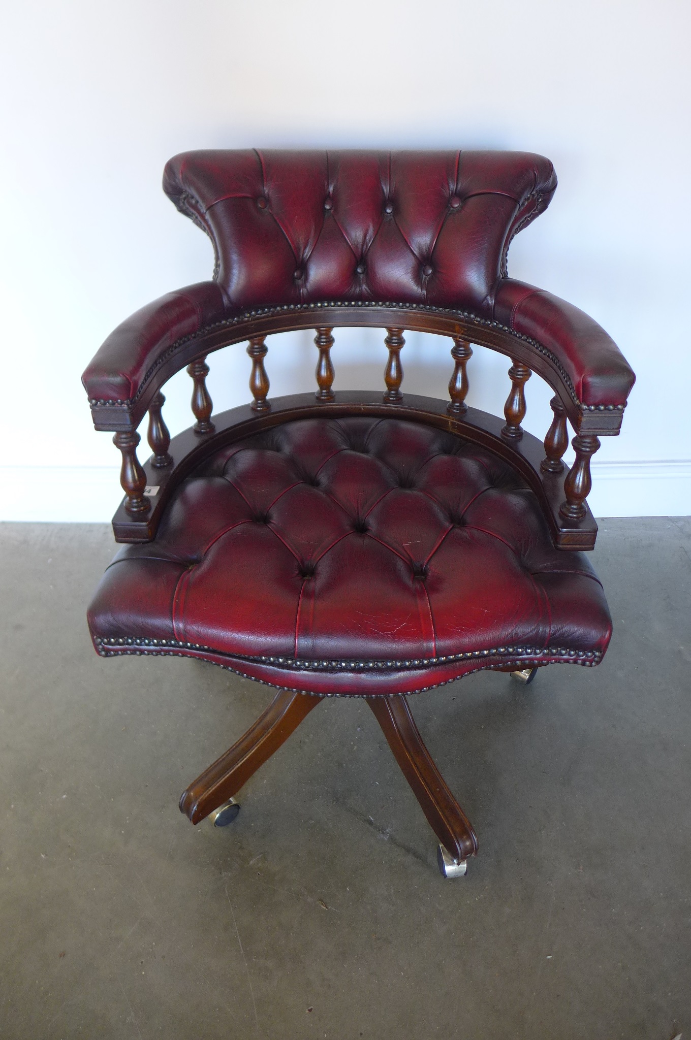 A leather tub shaped swivel desk chair