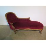 A Victorian scroll back buttoned chaise longue with foliate carving - 180cm long, 86cm tall x 77cm