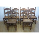 A set of six 18th/19th century oak dining chairs with solid seats and carved backs - 101cm tall