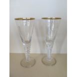 A pair of large engraved twisted stem wine glasses with good weight, 28cm tall, one with crest, both