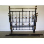 A Victorian brass and iron 4'6 inch bed with side rails, headboard 59 inches tall