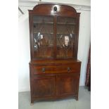 A Regency mahogany secretaire bookcase, arched cresting above a glazed rectangular doors flanked