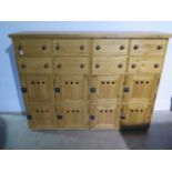 A good quality waxed pine bank of eight drawers and eight cupboards - 155cm wide