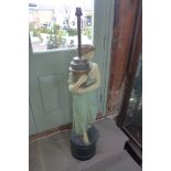 A large plaster figural lamp on a wooden base, 108cm tall, some chipping to plaster and has been