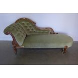 A Victorian carved walnut scroll back chaise longue with button material - 89cm tall x 187cm long