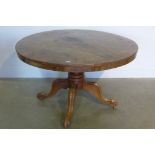 An early Victorian flame mahogany and rosewood cross banded tilt top breakfast table on quadruped