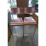 A pair of bronzed bar stools for indoor or outdoor use