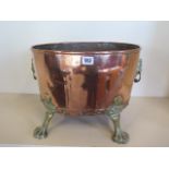 A copper and brass log bin, 32cm tall x 46cm x 34cm