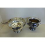 A silver plated punch bowl and two ladels and an ice bucket