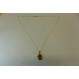 A 9ct gold and smoky quartz pendant on gold chain, pendant 25mm drop - in good condition