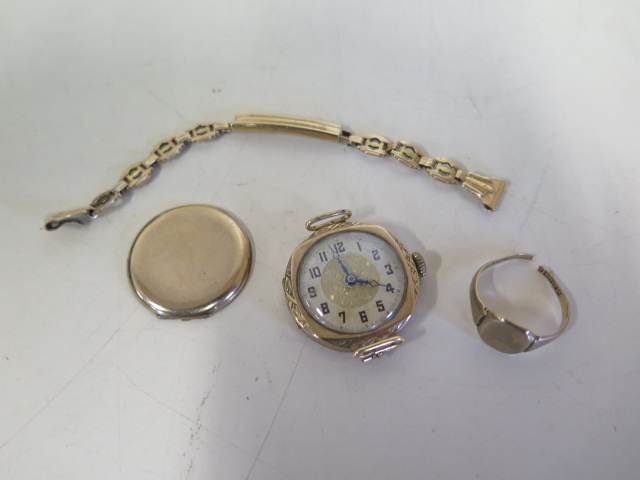 A 9ct yellow gold ladies manual wind wristwatch on a 14ct sprung strap, and a 9ct cut ring, back off