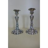 A pair of silver candlesticks with weighted bases Sheffield 1910/11 - maker JR - 19cm tall, in