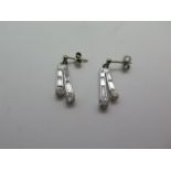 A pair of 18ct white gold baguette and brilliant cut drop earrings, 2cm long, approx 2 grams, in