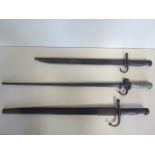 A spike bayonet with scabbard, total length 65cm, and two other bayonets